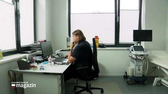 Arzt sitzt am Computer in seinem Behandlungsraum. © Screenshot 
