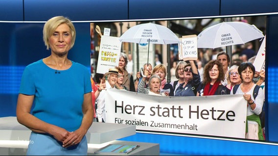 Nachrichtensprecherin Susanne Stichler, im Hintergrund ein Bild von einer Demonstration gegen Rechts. © Screenshot 