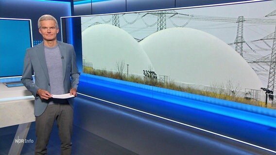 Nachrichtensprecher Thorsten Schröder, im Hintergrund ein Bild von einer Biogasanlage. © Screenshot 
