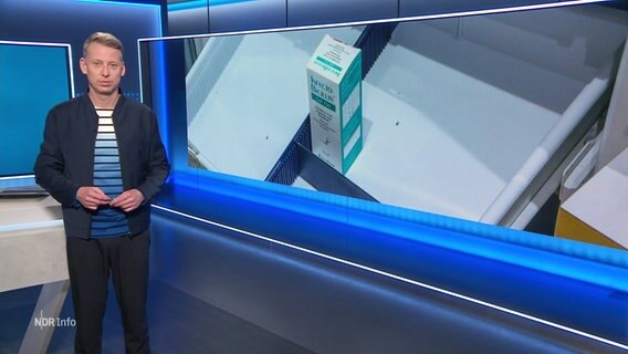 André Schünke moderiert NDR Info. Im Hintergrund ist ein leerer Apothekenschrank mit nur einem Medikament zu sehen. © Screenshot 