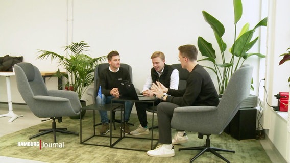 Drei Männer sitzen an einem Tisch. © Screenshot 