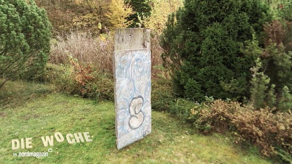 Ein Stück der Berliner Mauer in einem privaten Garten. © Screenshot 