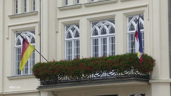 Der Balkon des Rathauses von Bützow, eingerahmt von der Flagge des Bundeslandes Mecklenburug-Vorpommern und der deutschen Nationalflagge. © Screenshot 