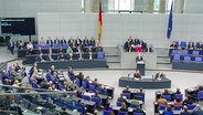 Olaf Scholz steht in der Mitte des Sitzungssaals des Bundestags. © Screenshot 