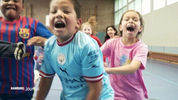 Kinder spielen in einer Sporthalle. © Screenshot 