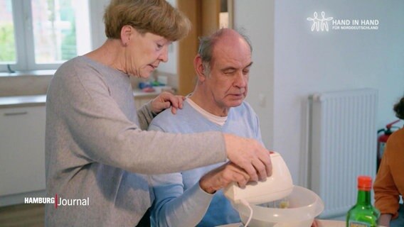 Eine Frau und ein Mann nutzen zusammen ein Rührgerät. © Screenshot 