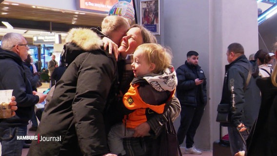 Eine Familie trifft sich am Hamburg Airport zum Weihnachtsfest wieder und umarmt sich. © Screenshot 