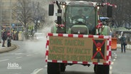 Ein Traktor mit einem Schild mit der Aufschrift: "Ohne Bauern wärst du nackt, hungrig und nüchtern." © Screenshot 
