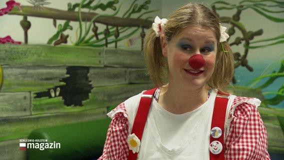Eine Frau verkleidet als Clown. © Screenshot 