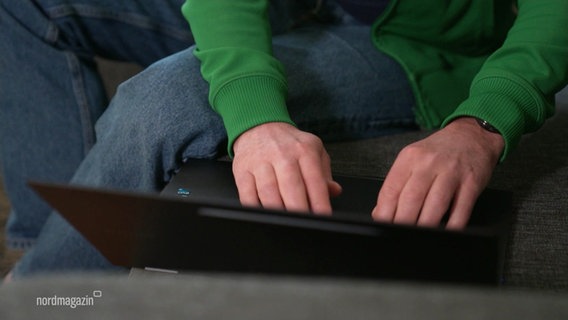 Von schräg oben gefilmt: Hände, die auf einer Laptop-Tastatur tippen. © Screenshot 