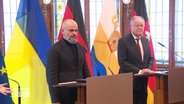 Mykola Marinov, stellvertretender Gouverneur der Region Mykolajiw in der Ukraine und Stephan Weil, Ministerpräsident von Niedersachsen, stehen jeweils an einem Rednerpult, im Hintergrund die Länderflaggen. © Screenshot 