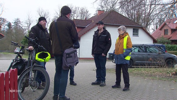 Vier Personen im Gespräch auf der Straße. © Screenshot 