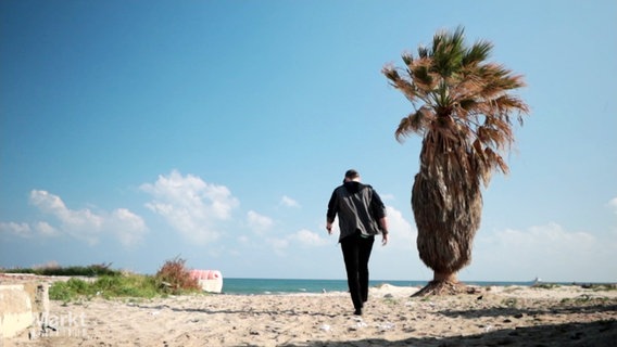 Ein Mann läuft an einem Strand entlang. © Screenshot 