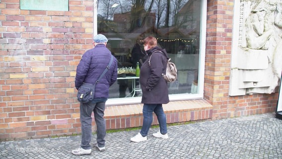 Ein Mann und eine Frau stehen vor einem Schaufenster. © Screenshot 