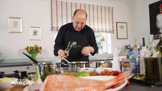 Dirk Luther beim Kochen in seiner Küche, im Vordergrund ein Fisch. © Screenshot 
