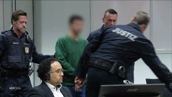 Der Angeklagte Ibrahim A. wird in den Gerichtssaal geführt. © Screenshot 