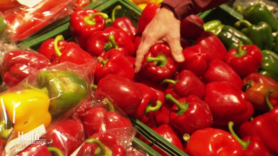 Eine Hand greift nach einer roten Paprike in der Gemüseabteilung. © Screenshot 