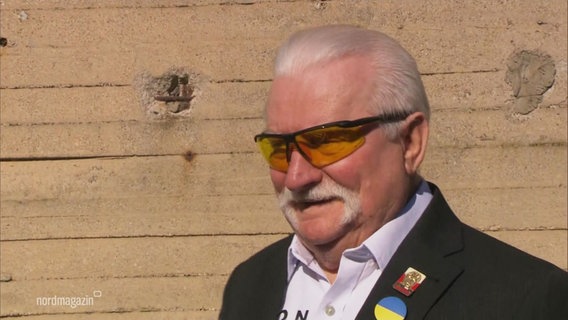 Ein Herr mit grauem Schnurrbart und sportlicher Sonnenbrille. © Screenshot 