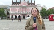 NDR Reporterin Juliane Schultz berichet vor dem Rostocker Rathaus. © Screenshot 