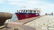 Ein Schiff liegt in einem Hafen. © Screenshot 