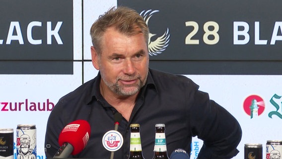 Der Trainer Bernd Hollerbach spricht bei einer Pressekonferenz. © Screenshot 