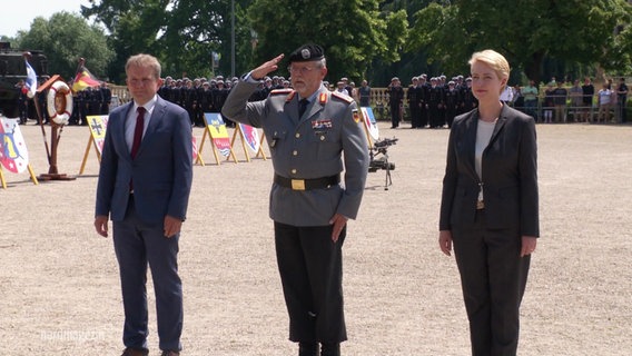 Schwerins OB Rico Badenschier und Ministerpräsidentin Manuela Schwesig - zwischen ihnen ein salutierender Soldat. © Screenshot 