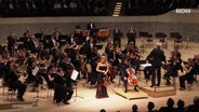 Ein Orchester auf der Bühne © Screenshot 