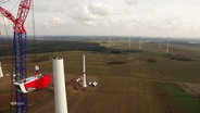 Eine im Bau befindliche Windkraftanlage. © Screenshot 