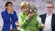 Merkel mit Äffchen auf der Schulter  