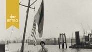 Bootsmann hisst US-Flagge an einer Barkasse  