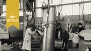 In einer Messehalle wird ein Kessel aufgebaut (1959)  