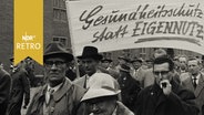 Demonstranten in Bremen am Tag der Arbeit 1960 mit dem Banner "Gesundheitsschutz statt Eigennutz"  