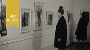 Zwei Besucherinnen betrachten Grafiken in einer Ausstellung (1961)  