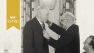 Jens Nydahl bekommt Auszeichnung für den langjährigen Vorsitz des Grenzfriedensbundes umgehängt (1961)  