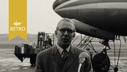 Der Schleswig-Holsteinische Ministerpräsident Kai Uwe von Hassel bei einem Statement auf dem Flughafen Berlin-Tempelhof 1961  