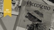 "Piccoletto" und andere Kinderbücher auf dem Tisch in einre Ausstellung 1962  