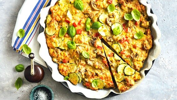 Schüttelpizza mit Gemüse und Basilikum in einer Tarteform. © NDR 