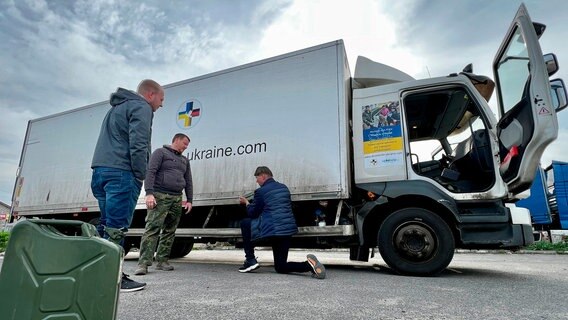 Die Auslieferung der Hilfsgüter verzögert sich. Dennis Post, Michael Kröger und Hans de Boer (v.r.) aus Niedersachsen sind mit ihrem Lkw in Charkiw liegengeblieben. Die Auslieferung der Hilfsgüter verzögert sich. Dennis Post, Michael Kröger und Hans de Boer (v.r.) aus Niedersachsen sind mit ihrem Lkw in Charkiw liegengeblieben. © NDR/William Dubas
