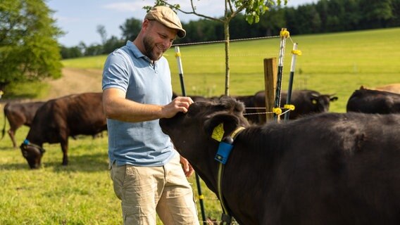 Georg Mayerhofer baut den Elektro-Weidezaun für seine Wagyu-Rinder auf. © NDR/Ludwig Noack 