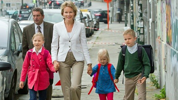 Mathilde, Kronprinzessin von Belgien, mit ihren Kindern (von links) Prinzessin Elisabeth, Prinzessin Eleonore und Prinz Gabriel auf der Straße. © picture alliance / dpa Foto: Patrick van Katwijk