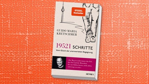 Zu sehen ist das Cover des Buchs "19.521 Schritte. Vom Glück der unerwarteten Begegnung" von Guido Maria Kretschmer, erschienen im Heyne Verlag. © Heyne Verlag 