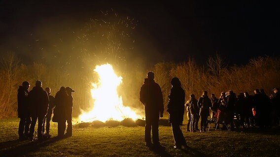 Menschen stehen um ein großes Lagerfeuer. © NDR Foto: Helmut Kuzina aus Wismar