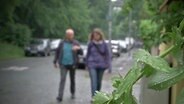 Zwei Menschen gehen auf einer Straße  