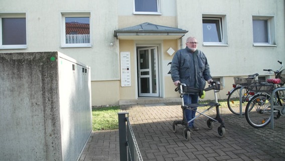 Ein Mann mit Rollator verlässt sein Haus. © NDR 