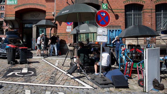 Vier schwarze Schirme sind vor dem Speicherhaus aufgebaut. © NDR Foto: Claudia Timmann