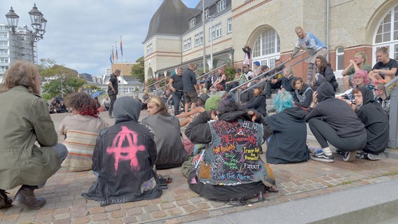 Punks sitzen vor dem Rathaus gegenüber von ihrem Protestcamp. © picture alliance Foto: Bernd Kammerer