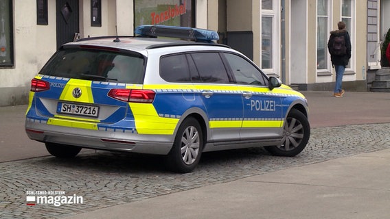 Ein Streifenwagen der Polizei steht in einer Fußgängerzone. © NDR 