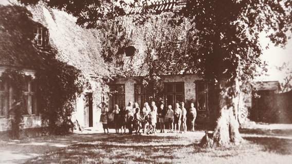 Eine historische Aufnahme zeigt Kinder vor dem Gebäude des Landgymnasiums in Satrup. © Walter Clausen 