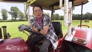 Eine Frau sitzt auf einem Trecker. © NDR 