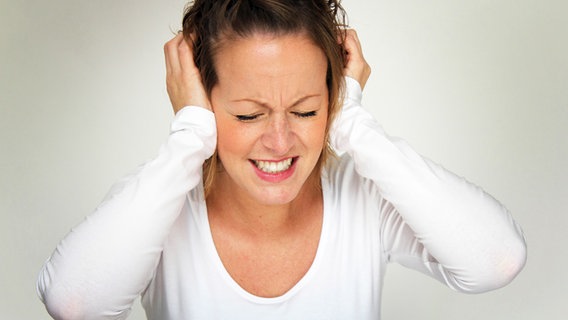 Frau hält sich gestresst die Ohren zu © Fotolia.com Foto: #CNF